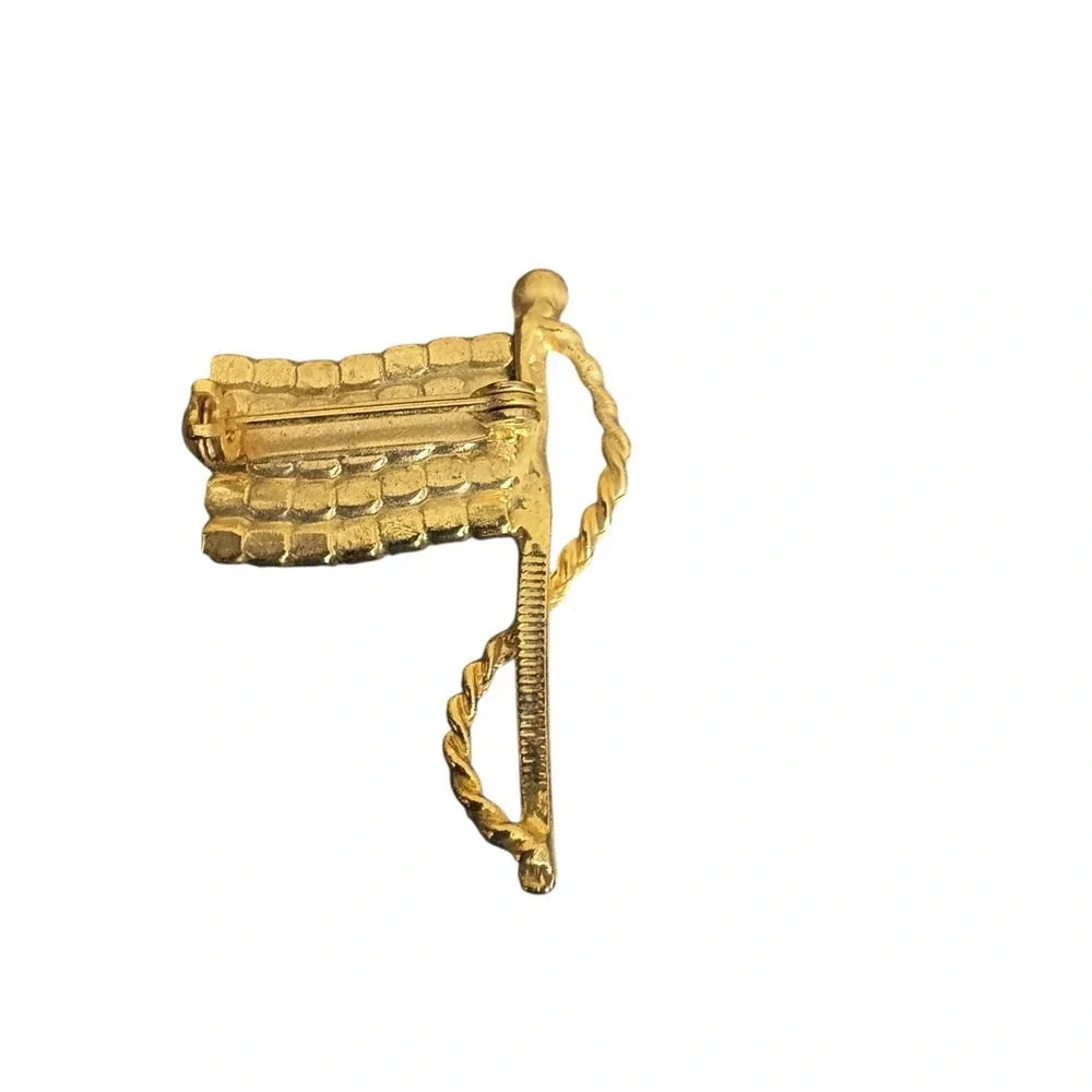 Patriotic gold-tone American flag brooch featuring red, white, and blue rhinesto